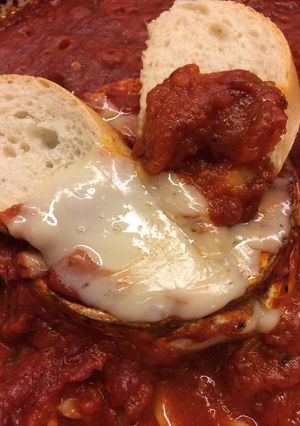 A picture of Baked Goat Brie in Spicy Garlic Tomato Sauce.