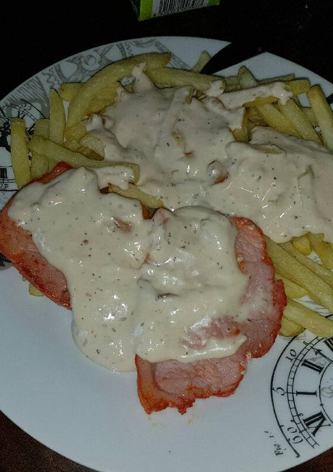 Una foto de Lomo al ajillo y nata acompañado de papas fritas