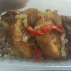 A picture of Fried yam with fried egg and sauce.