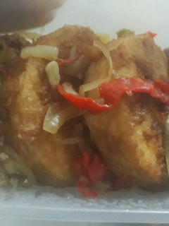 A picture of Fried yam with fried egg and sauce.