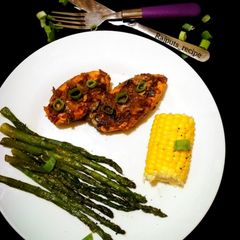 A picture of Roasted Masala Salmon Asparagus and butter corns.