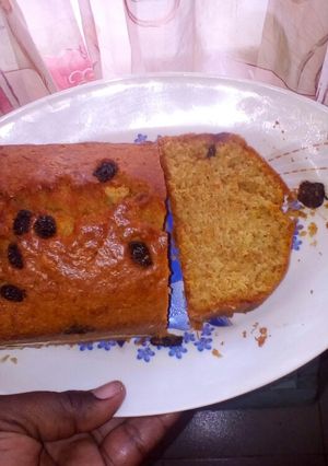A picture of Carrot cake with raisins on top.