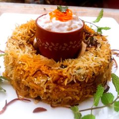 A picture of Shahi Mushroom and Baby Corn Biryani.