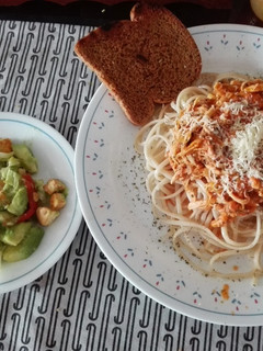 Una foto de Espaguetis con pollo y ensalada con croutones
