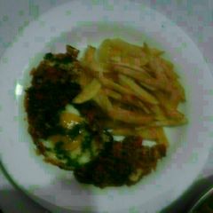 A picture of Shakshuka With french fries.