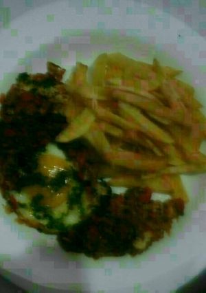 A picture of Shakshuka With french fries.
