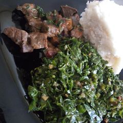 A picture of Ugali, steamed kales and liver.
