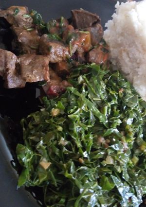 A picture of Ugali, steamed kales and liver.