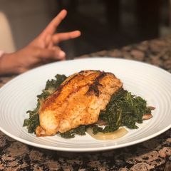 A picture of Blackened Catfish and Sautéed Kale.