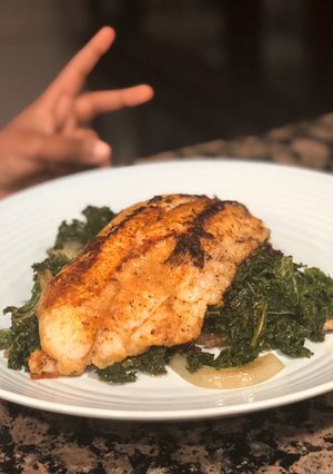 A picture of Blackened Catfish and Sautéed Kale.