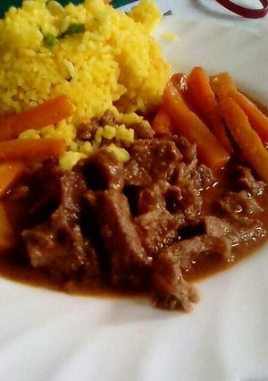 A picture of Rice beef served with carrots.