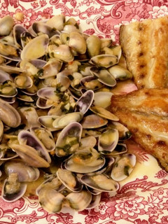 Una foto de Coquinas salteadas con txakolí y corvina a la plancha