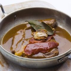 A picture of Portuguese steaks in the sauce.
