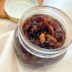 A picture of Red onion chutney with nuts and raisins.