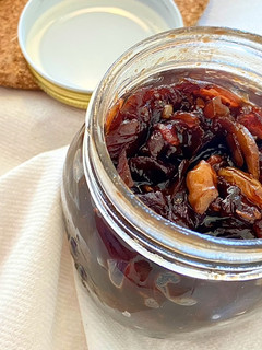 A picture of Red onion chutney with nuts and raisins.