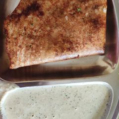 A picture of Crispy Onion chilli dosa with chutney.
