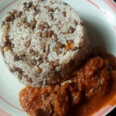 A picture of Rice and beans with stew.