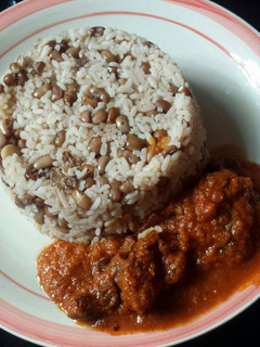 A picture of Rice and beans with stew.