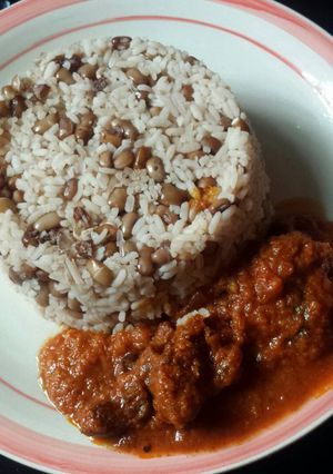 A picture of Rice and beans with stew.