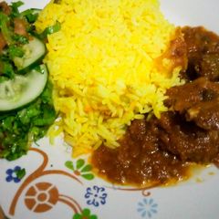 A picture of Turmeric-vegy rice with stew and salad.