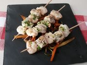 Una foto de brochettes de langostinos
