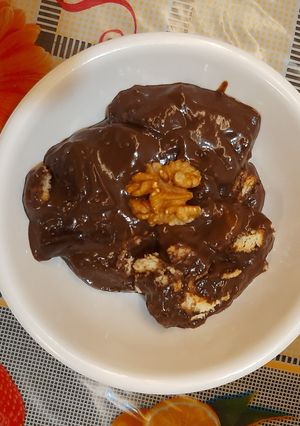 A picture of Chocolate dessert loaded with dry fruits.
