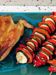 Una foto de Picantón asado y brochetas de verduras