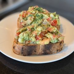 A picture of Guacamole on sourdough toast.