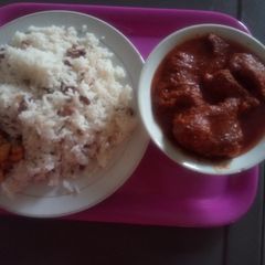 A picture of White Rice mixed with Beans and diced plantain with stew.