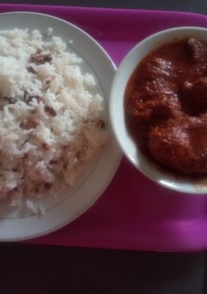 A picture of White Rice mixed with Beans and diced plantain with stew.