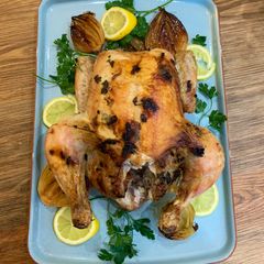 A picture of Garlic butter roast chicken with caramelised onions.
