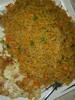 A picture of Spicy indomie with fried egg.