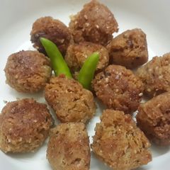 A picture of Til narkol postor bora (Sesame coconut and poppy seed fritters).