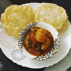 A picture of Luchi & Alur Dom / Puri with Potato Curry.