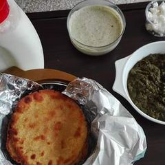 Sarson ka Saag and Makki ki Roti Lassi Podina Chutney and Makkan A picture of Sarson ka Saag and Makki ki Roti Lassi Podina Chutney and Makkan.