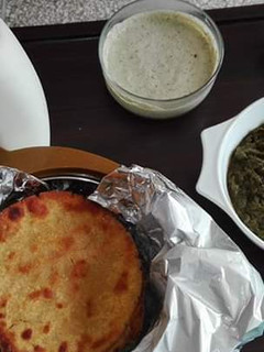 A picture of Sarson ka Saag and Makki ki Roti Lassi Podina Chutney and Makkan.