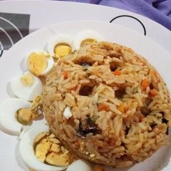 A picture of Native Oil Jollof Rice with Boiled Eggs.