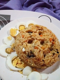 A picture of Native Oil Jollof Rice with Boiled Eggs.