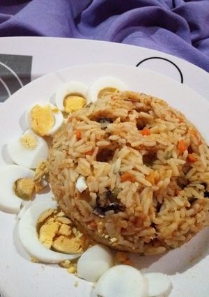 A picture of Native Oil Jollof Rice with Boiled Eggs.