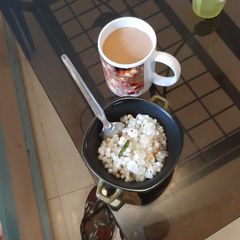 A picture of Sabudana khichdi with masala tea.