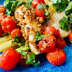 A picture of Fish with chargrilled garlic tomatoes and lemon olive oil dressing.