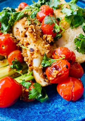A picture of Fish with chargrilled garlic tomatoes and lemon olive oil dressing.