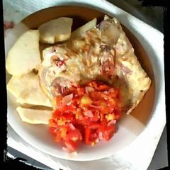 A picture of Fried Yam with fried eggs and sauce.