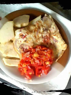A picture of Fried Yam with fried eggs and sauce.