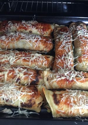 Una foto de Canelones de espinaca con salsa