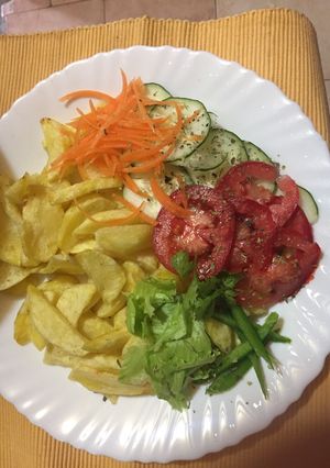 A picture of Rosemary garlic potato wedges with salad.