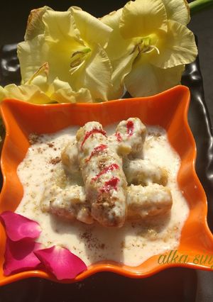 A picture of Stuffed Sweet potato rolls in milk rabri.