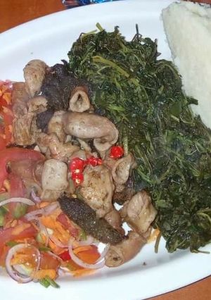 A picture of Fried Matumbo, Kachumbari, boiled dodo and Ugali.