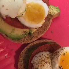 A picture of Avocado and egg open faced English muffin.