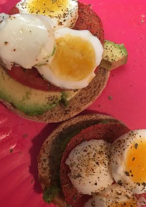 A picture of Avocado and egg open faced English muffin.